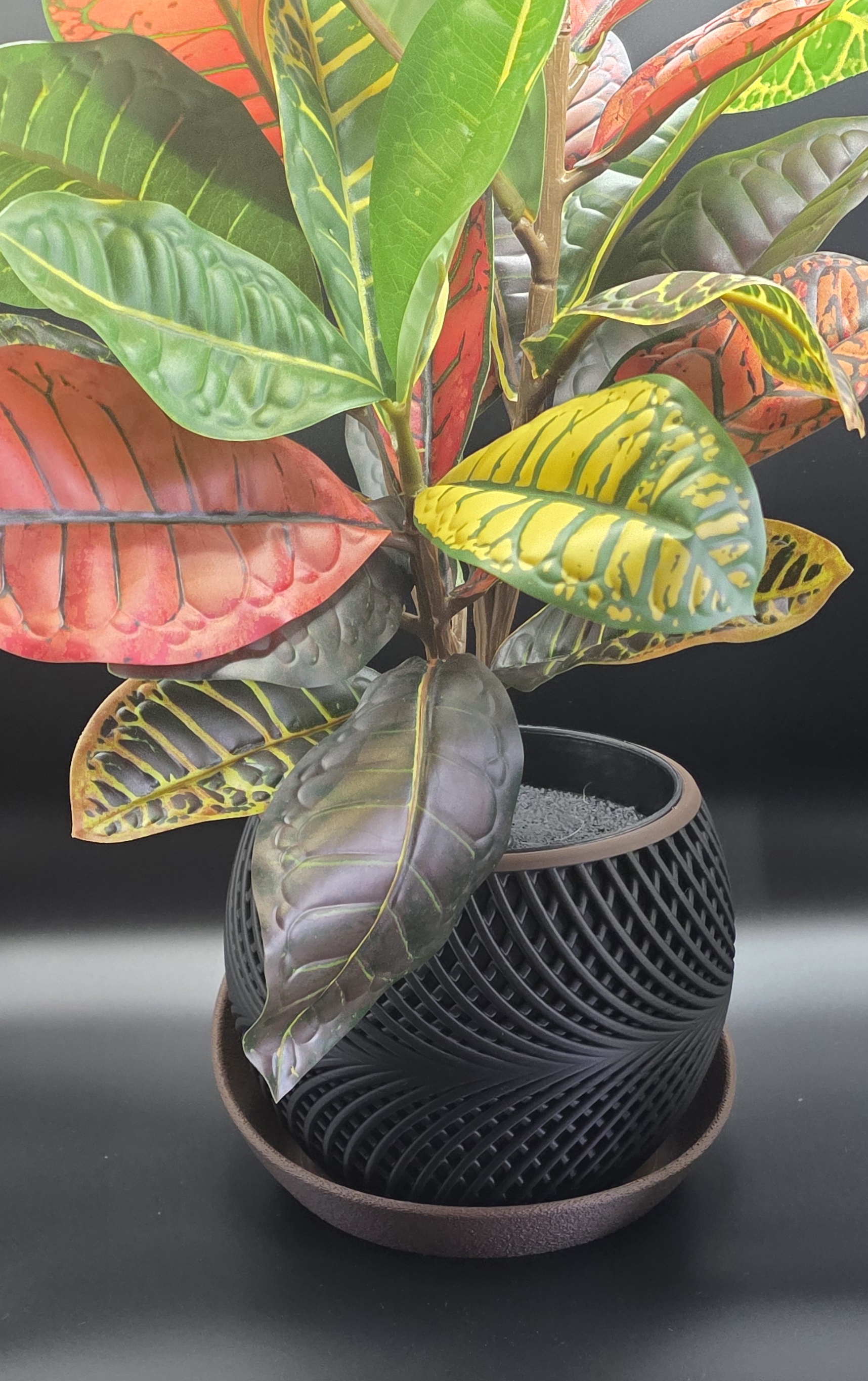 3D printed white planter with flowing spiral ribs and saucer